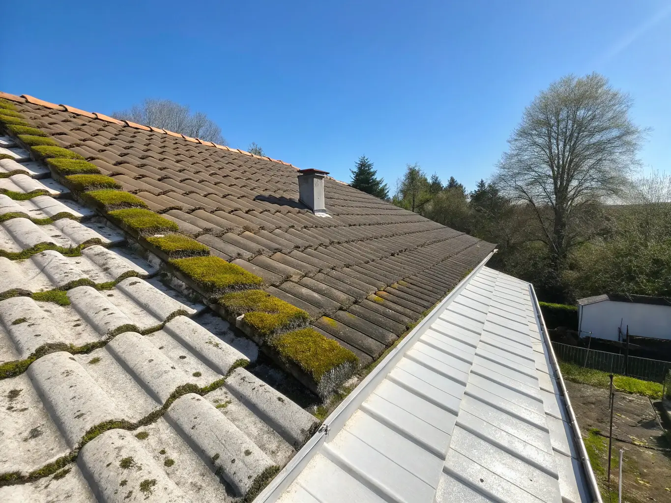A roof before and after cleaning, showing a significant reduction in moss and stains, demonstrating the effectiveness of So Clean Soft Wash's roof cleaning service.